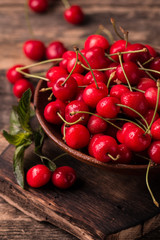  Ripe Cherries on wooden table with water drops