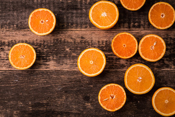 Fresh half cut oranges on wooden table