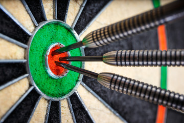 three darts in bull's eye, close up
