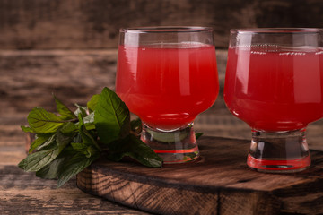 Citrus juice and fruits on wooden background.