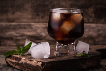 cold drink with ice on wooden vintage table