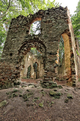 Fototapeta na wymiar Broken church walls in the forest
