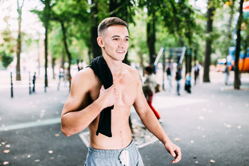 Outdoor portrait of healthy handsome active man with fit muscular body, sports and fitness concept