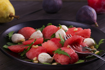 Watermelon, Mozzarella cheese and Arugula Salad with Pine Nuts. Healthy Vegetarian and Detox Salad.  View from above, top studio shot