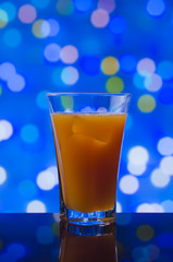 the refreshing juice with ice on a bright background