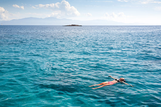Swimming blue lagoon. Woman and ocean.