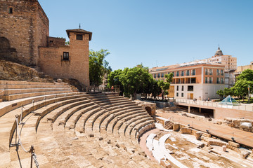 Sunny view of ancient amphitheater Teatro Romano de Malaga,  Malaga, Andalusia province, Spain.