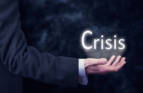 Businessman holding a Crisis Concept