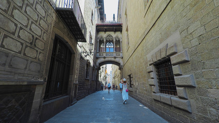 BARCELONA CATALONIA SPAIN - JULY 2016: Smooth camera steady shot along narrow street in the center...