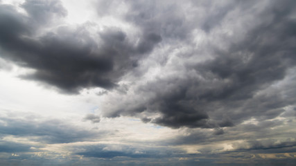 Beautiful summer day sky. Dense crisp cloudscape with large, building clouds, light rays and close to storm sky, perfect for digital composition background.