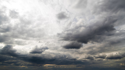 Fototapeta premium Beautiful summer day sky. Dense crisp cloudscape with large, building clouds, light rays and close to storm sky, perfect for digital composition background.