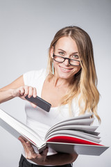 woman in glasses photographed text book into a phone