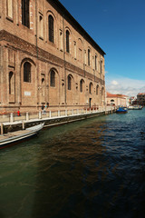 Fototapeta na wymiar Canal ( channel ) in Venice in a bright day.