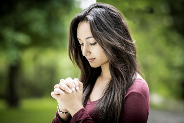 Woman praying outdoors