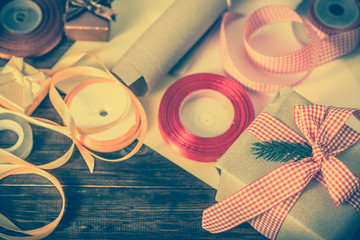 Rustic Christmas gift wrapped in old paper and pink ribbon