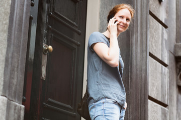 Woman on the Phone before a Building