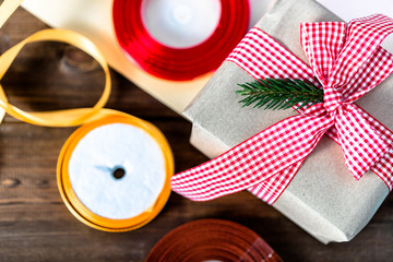 Rustic Christmas gift wrapped in old paper and pink ribbon