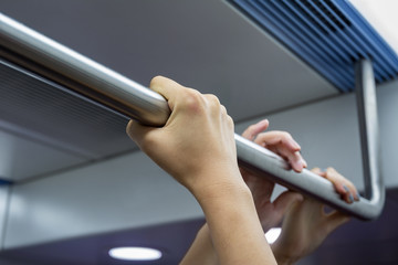 People holding handrail tightly on work or after work.