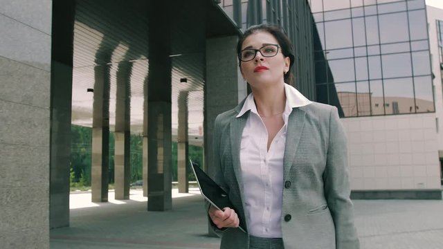 Attractive business woman running to the office