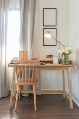 wooden chair and table with modern lamp in working space