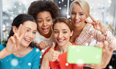 happy young women taking selfie with smartphone