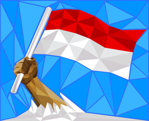Strong Hand Raising The National Flag Of Indonesia