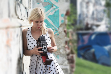Young woman holding a medium format photography camera