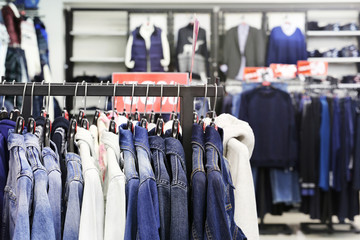 Fashion clothes shop. Clothes on hanger in shop