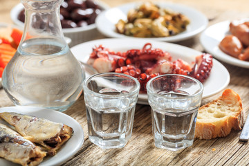 Two glasses of ouzo and appetizers