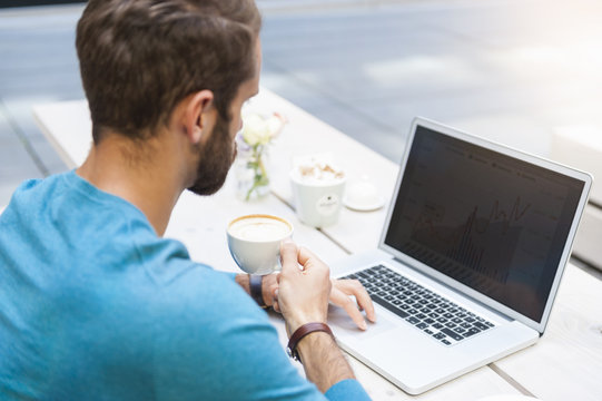 Businessman analyzing data on laptop display