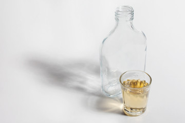 Shot glass of Brazilian cachaca isolated on white background