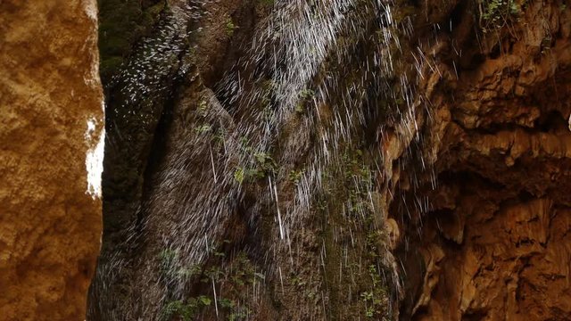  water falling blurred by the wind backlit 