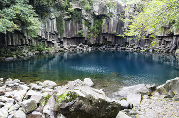 Fototapeta na wymiar Waterfall and blue lake in the Jeju island in South Korea