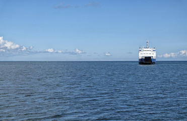 Ferry on blue wavy sea