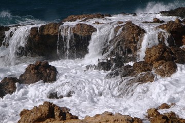 Big waves crashing on rocks in Paros Aegean island