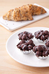 Chocolate and bun on wood table