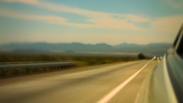 A time lapse of a sports car speeding along the highway.