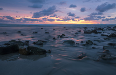 Fototapeta na wymiar Ocean in motion/Ocean moving over rocks at sunset