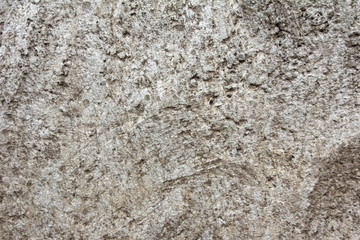 Eroded old grey concrete at a wall for dirty texture, background