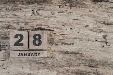 Cube calendar for january on wooden background with copy space