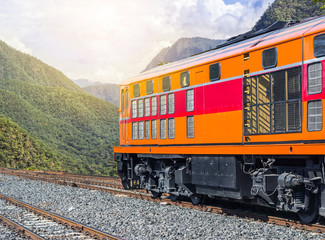 diesel engine locomotive passenger train crossing  valley mountains
