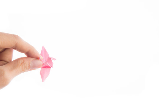 Woman hand taking bird paper origami