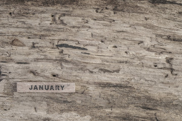 Cube calendar for january on wooden background with copy space