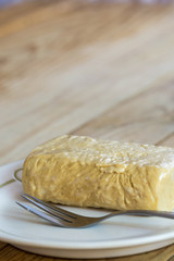 Sweet halva on the plate on the wooden old retro table