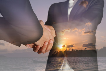 Double exposure of business women double handshake and sunrise in the morning at the beach as  congratulation concept.
