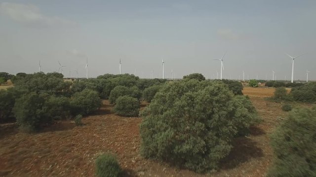 Approaching very fast to wind turbines aerial view, 4k