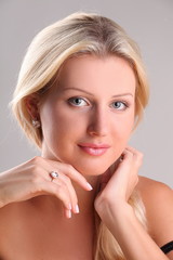 Beautiful young blonde shows off jewelry ring with stone