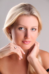 Beautiful young blonde shows off jewelry ring with stone