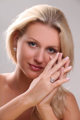 Beautiful young blonde shows off jewelry ring with stone