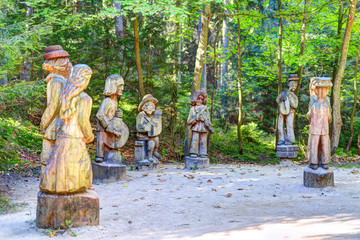 Old wooden sculptures in the forest. Witch Hill park, Lithuania.